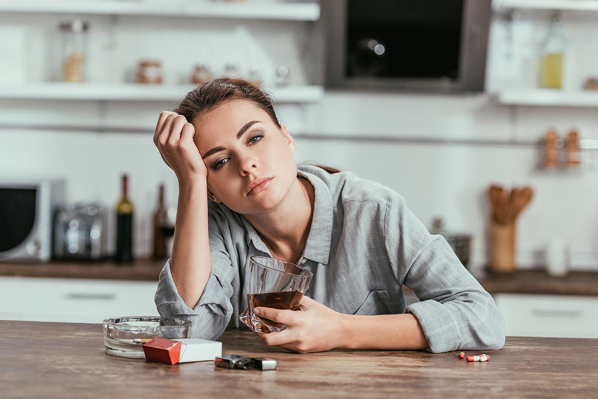 sadness woman with alcohol addiction holding whisk